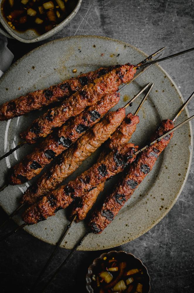 Top view of vegan barbecue skewers laid on a plate.