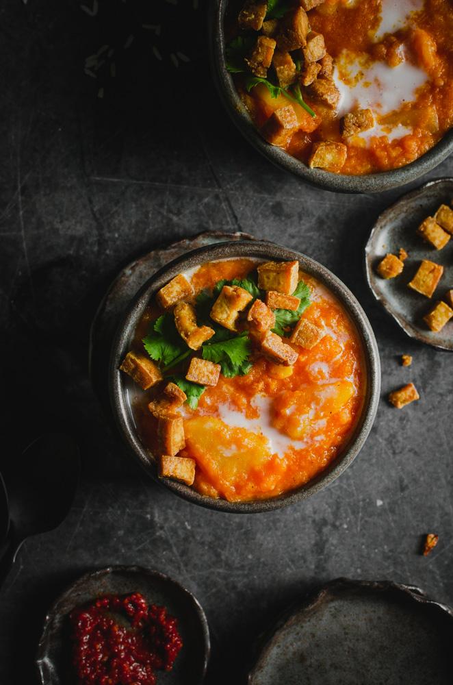 Top view of two bowls of vegan chamoru chalakilis soup.