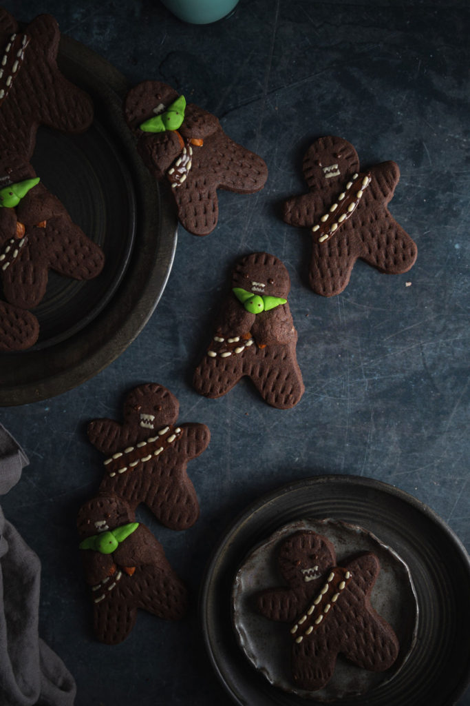 Top view of vegan wookie cookies laid on a work surface and on some plates.