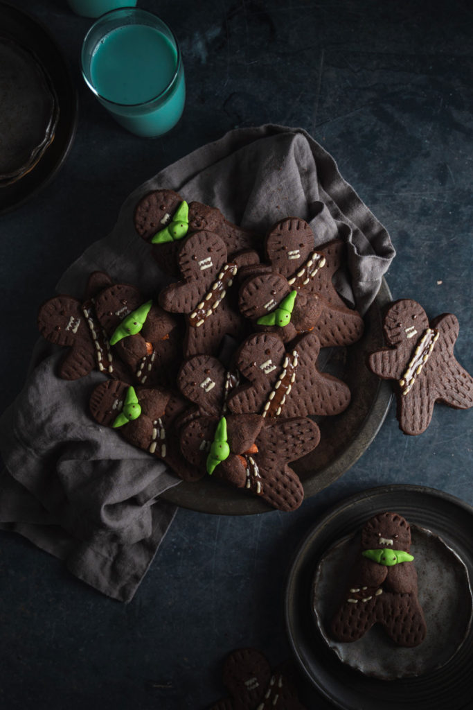 Top view of an army of vegan wookie cookies laid on top of plate.