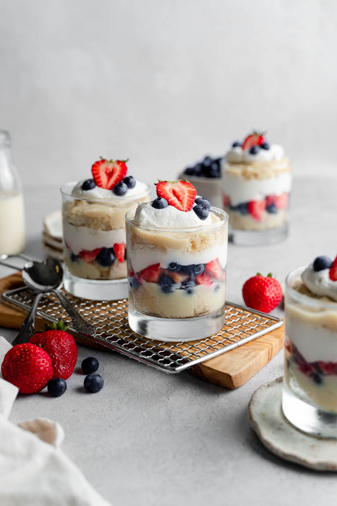 A single trifle cup in the center and in focus, two cups in the back, out of focus.