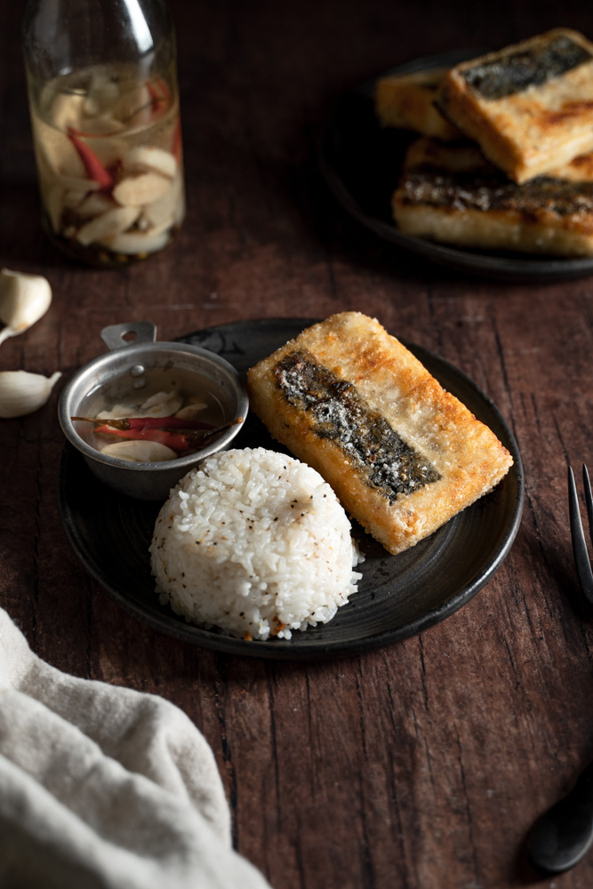 Plate of a piece of vegan bangus, garlic fried rice, and vinegar sauce.