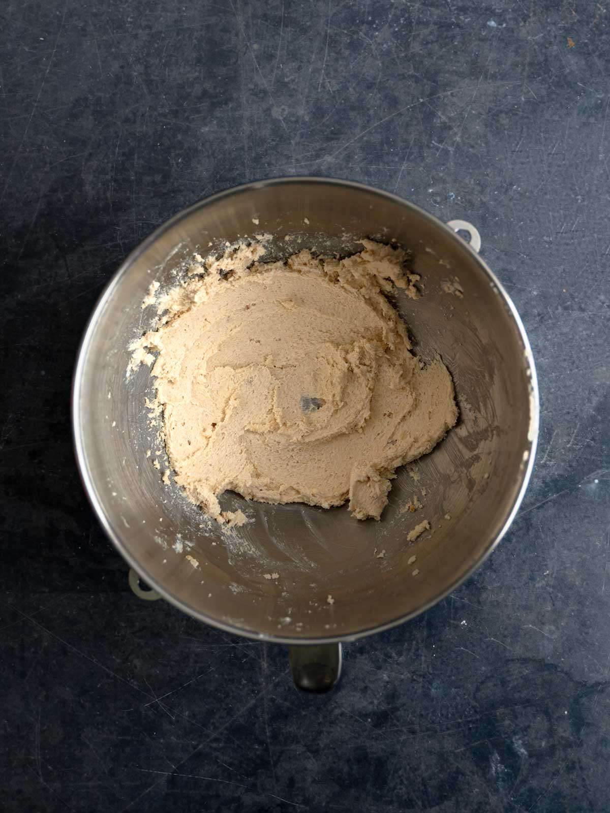Butter and sugar creamed in a metal bowl.