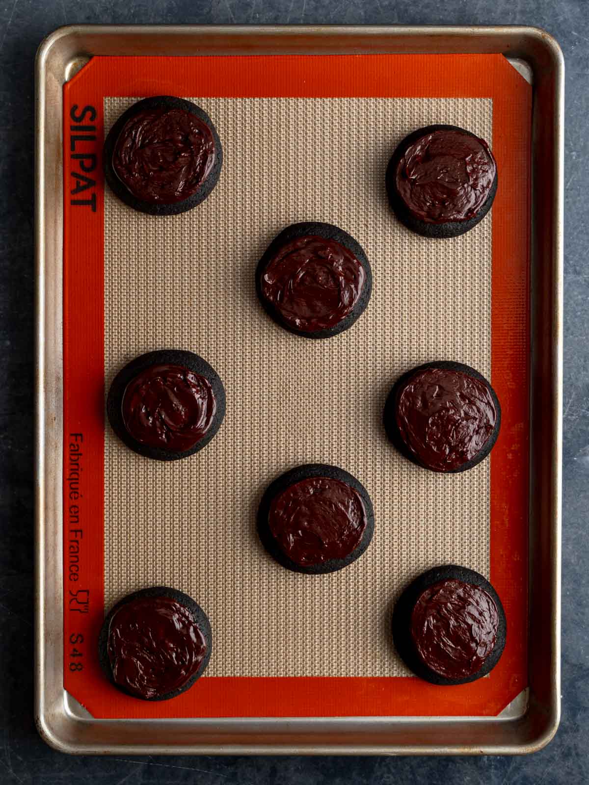 Ganache spread over the top of the cooled cookies.