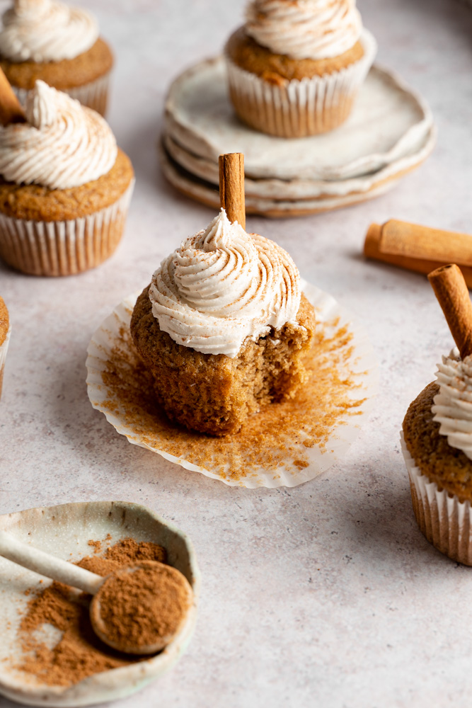 One cupcake with a bite taken out of it.