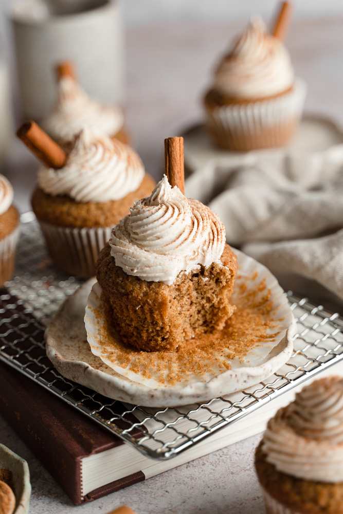 A single vegan chai latte cupcake with a bite taken out of it.