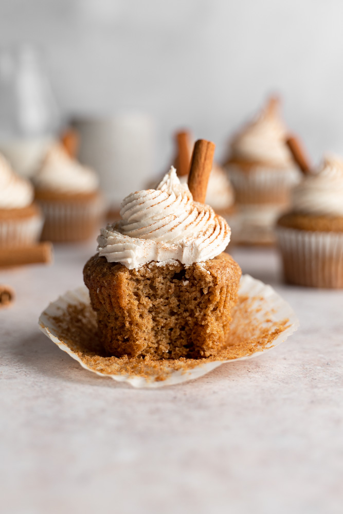A single cupcake with a bite taken out of it.