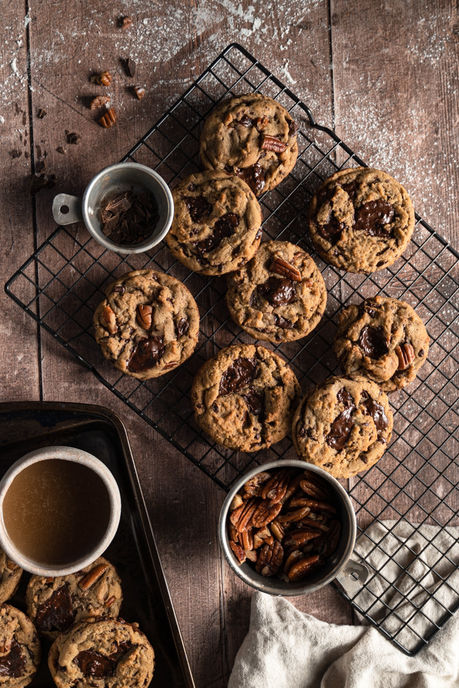 vegan brown butter chocolate chip cookies set on top of a wire rack.