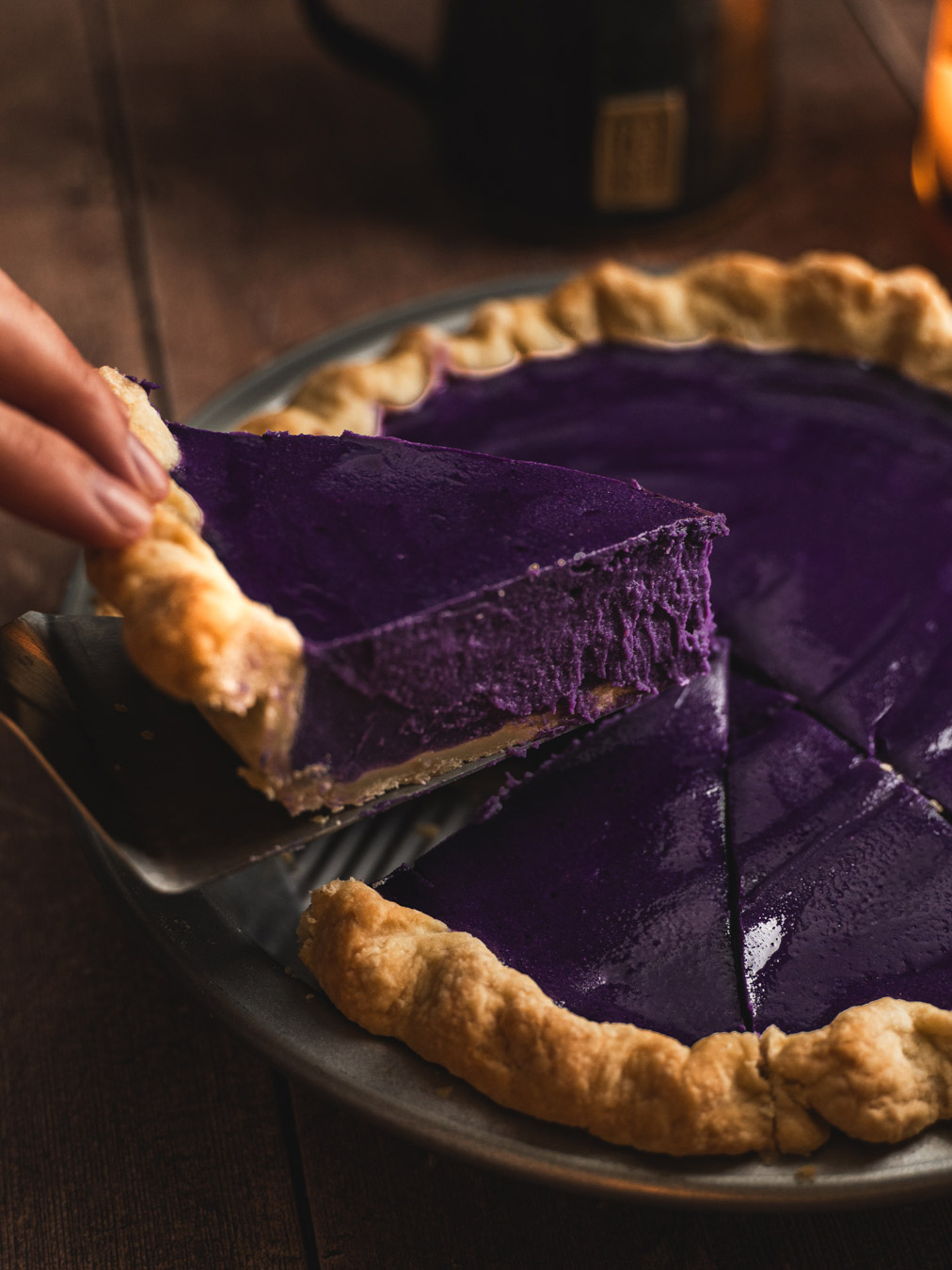 A slice of ube being served.
