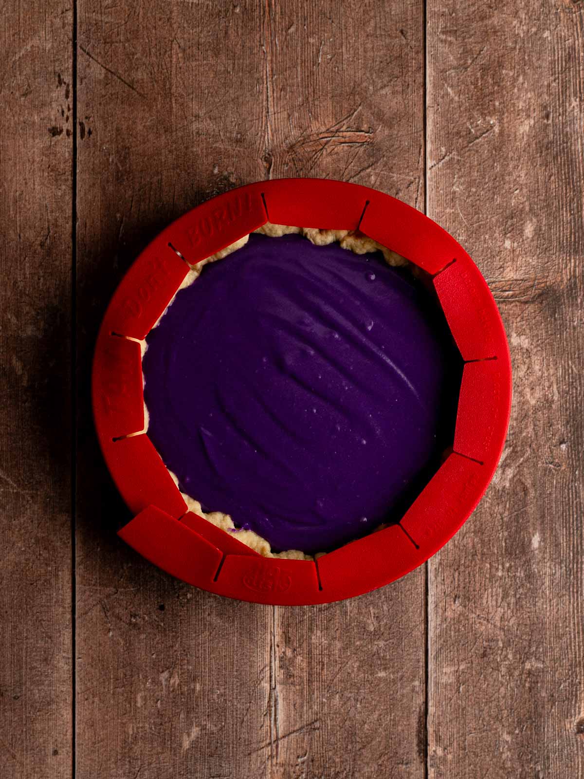 Filled the blind baked pie crust with ube filling and the edges covered with a pie shield.