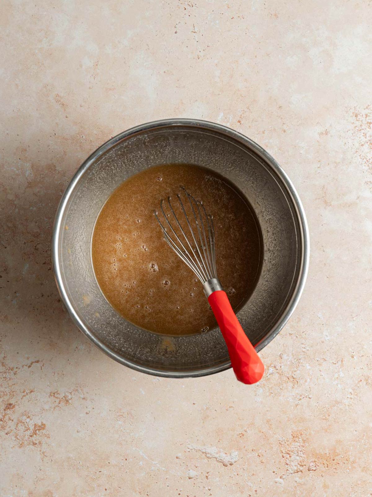 Mixing wet ingredients in a separate bowl.