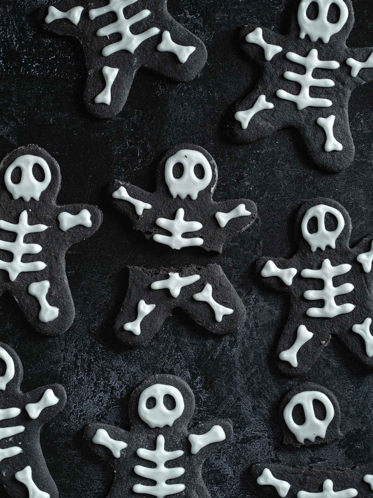 A broken skeleton cookie surrounded by other cookies.