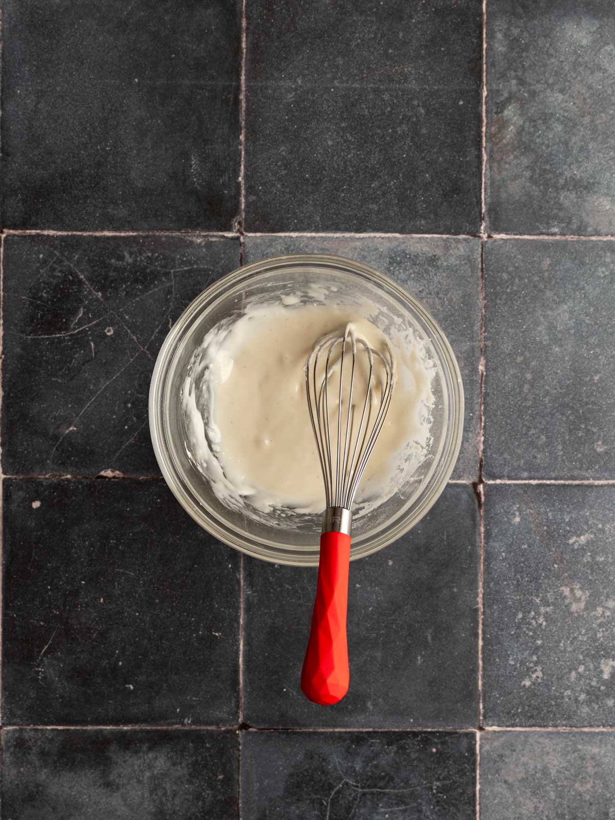 Ingredients for icing mixed in a bowl.