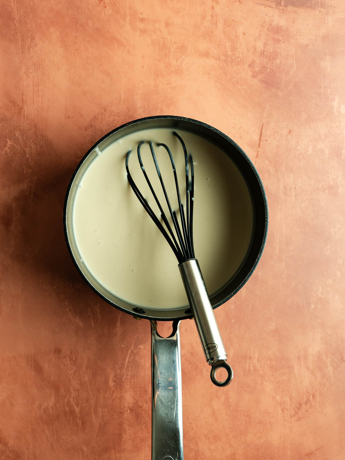 Blended flan mixture in a saucepan.