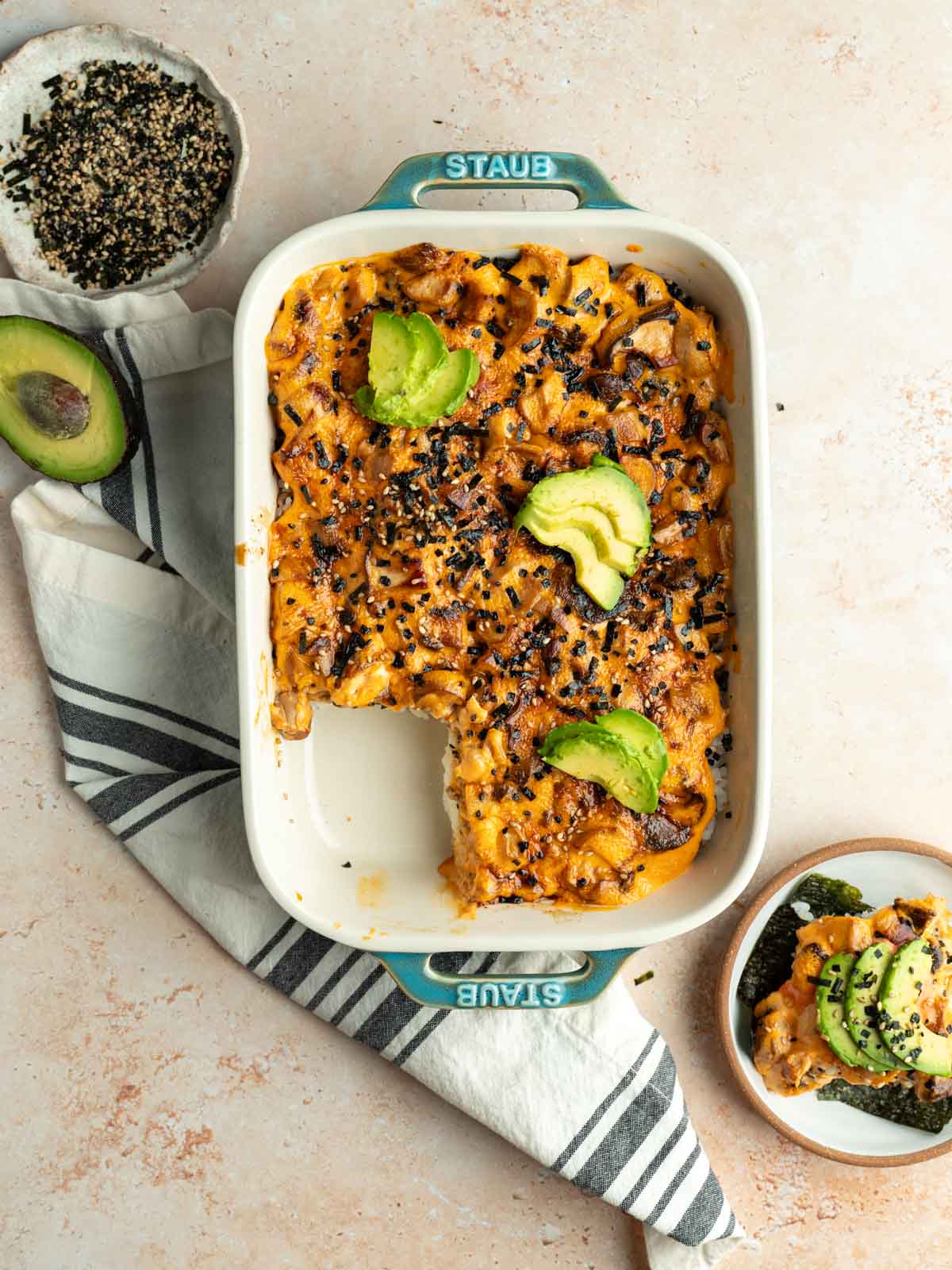 Cooked vegan sushi bake with a serving taken from it.