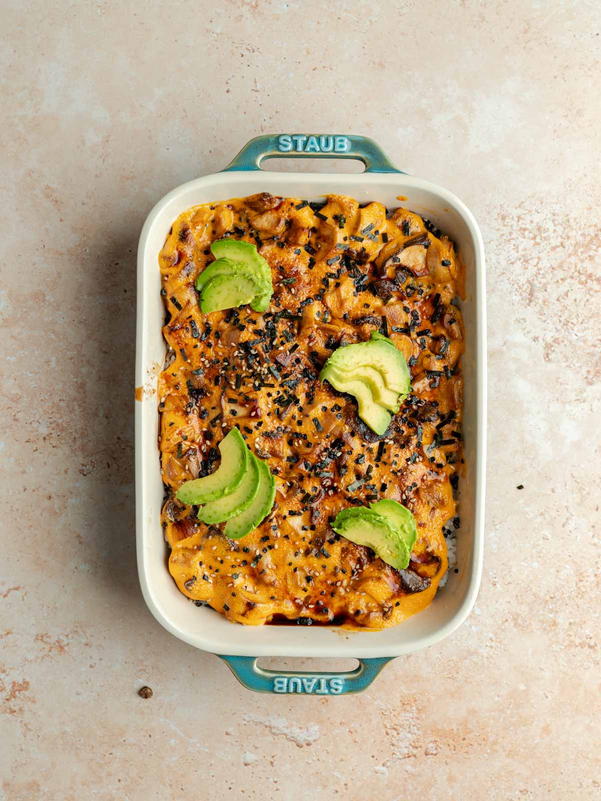 Furikake and avocado spread over top the broiled sushi bake.