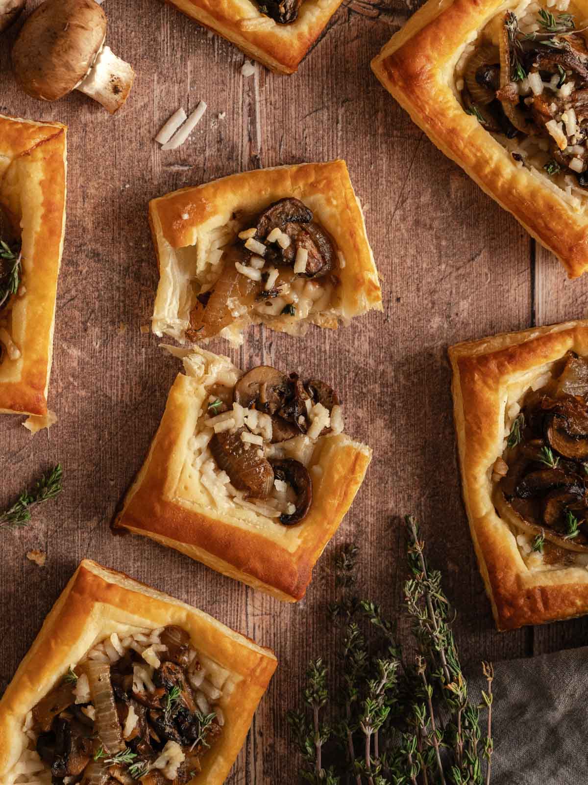 A cheesy mushroom tart torn in the middle.