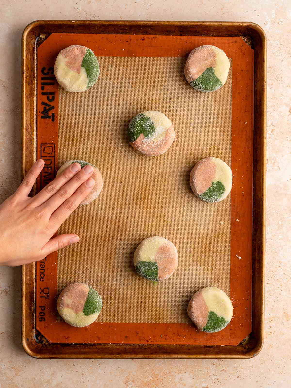 Unbaked cookies on a rimmed baking sheet.