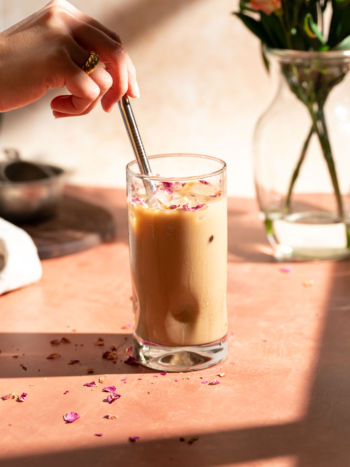 Stirring a glass of rose cardamom latte.