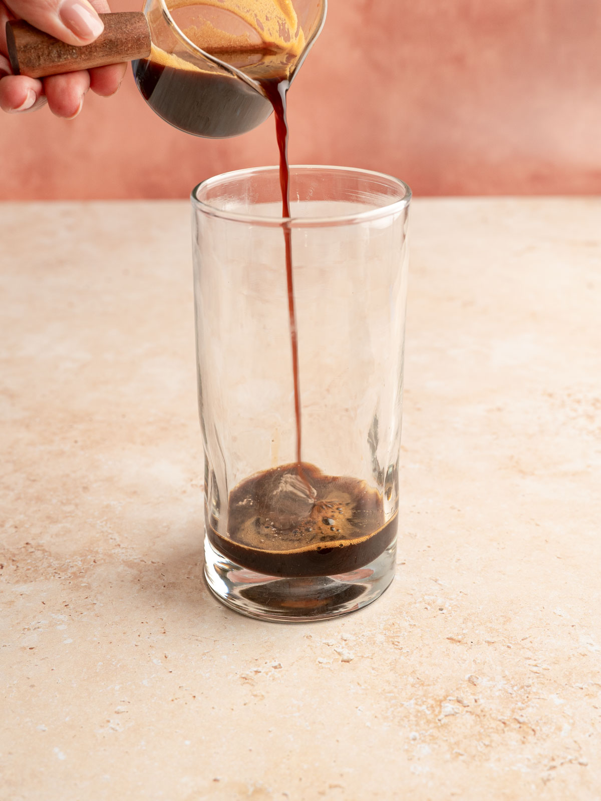 Espresso poured into a glass.