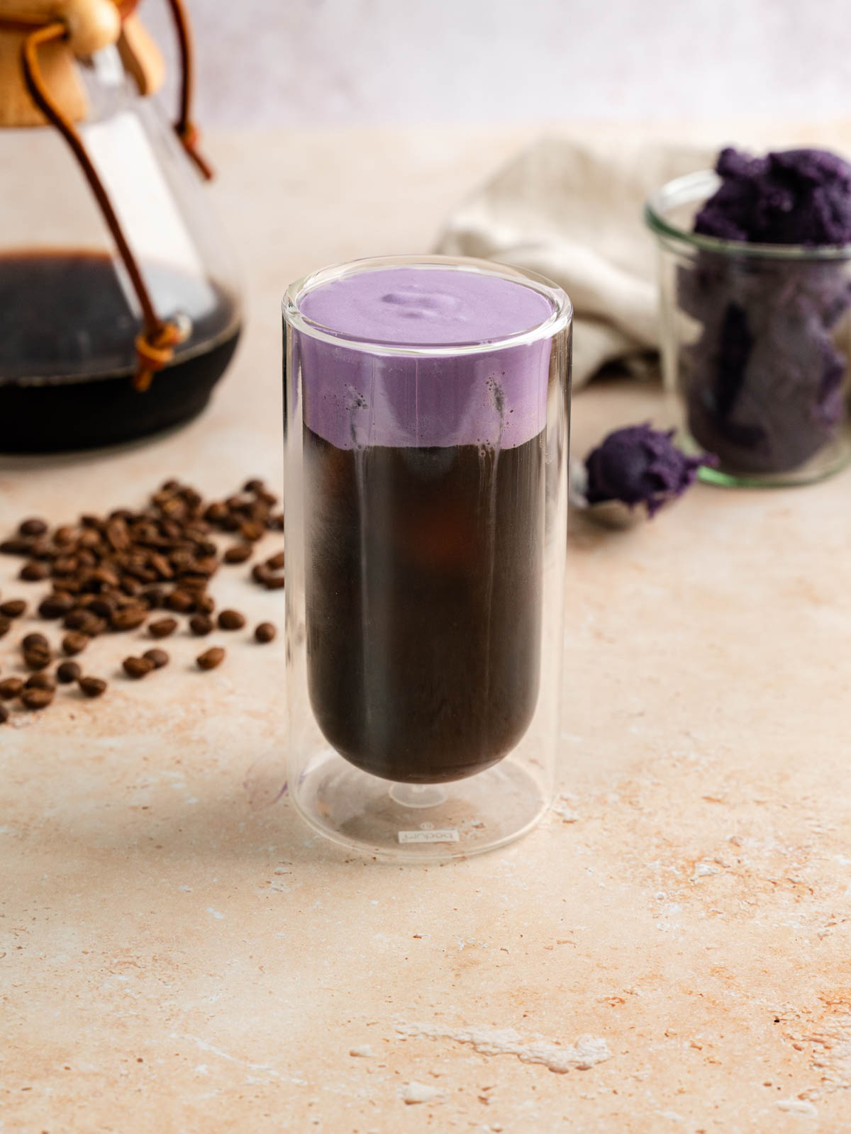 Tall glass of vegan ube cream cold brew.