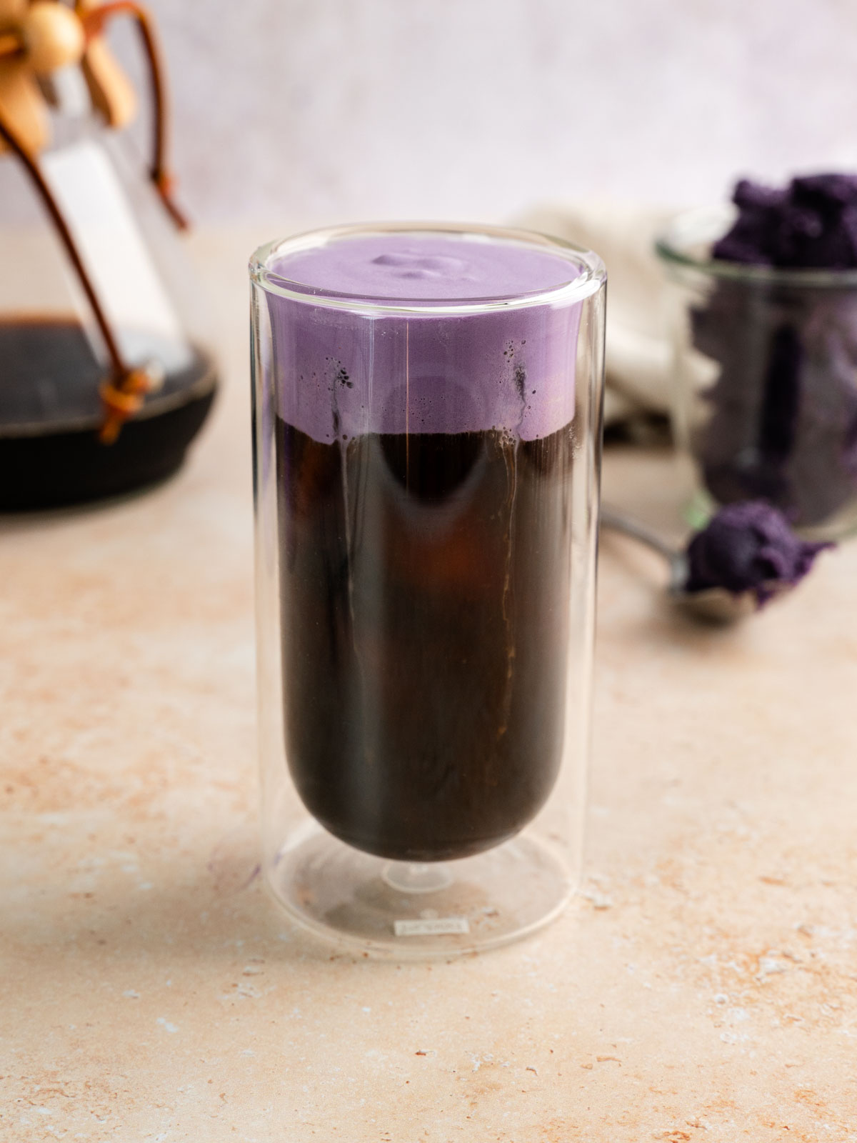 A tall glass of vegan ube cream cold brew.