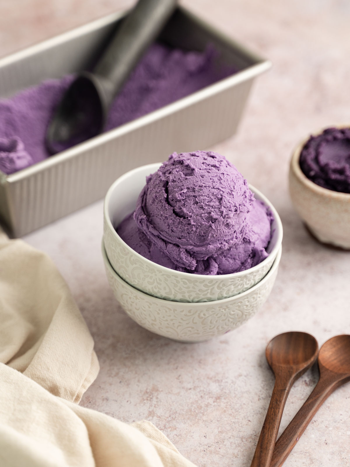 Scoops of ube ice cream in a bowl.