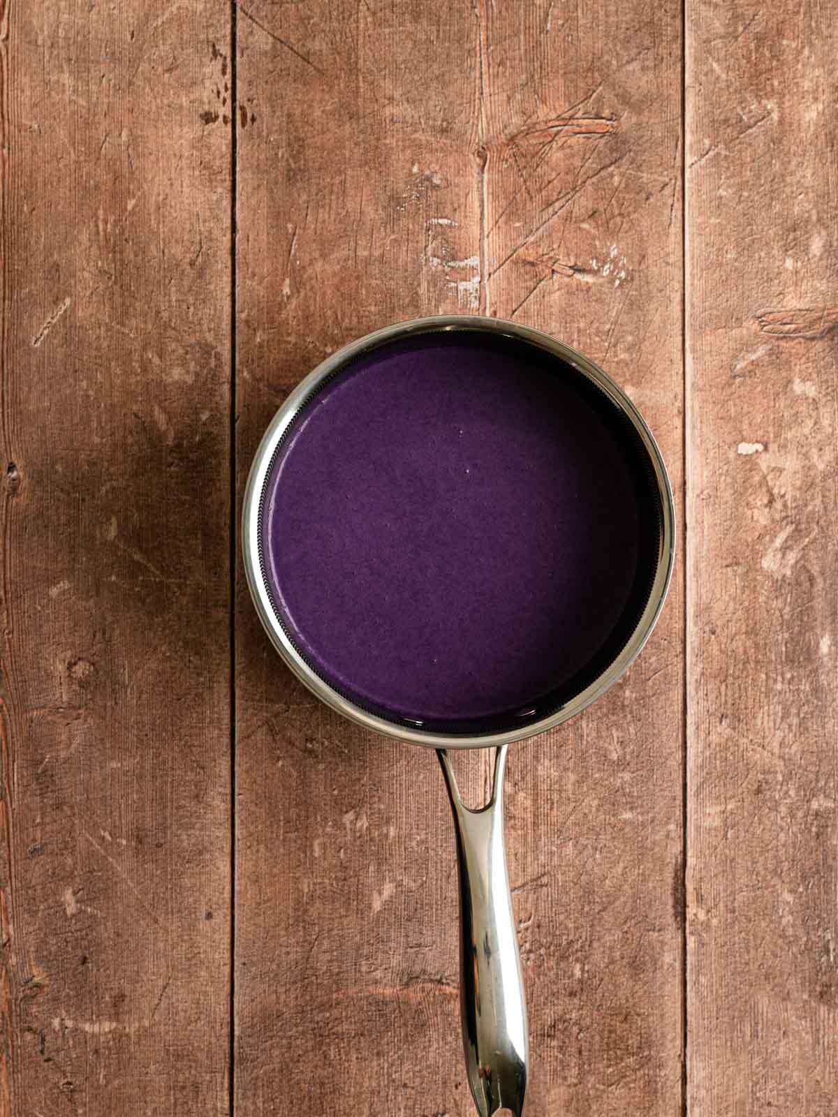 Cooked ube flan mixture in a saucepan.