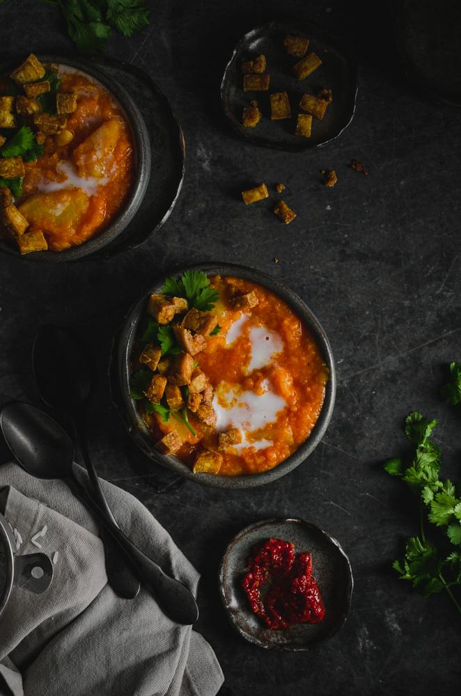 Top view of two bowls of vegan chamoru chalakilis soup.