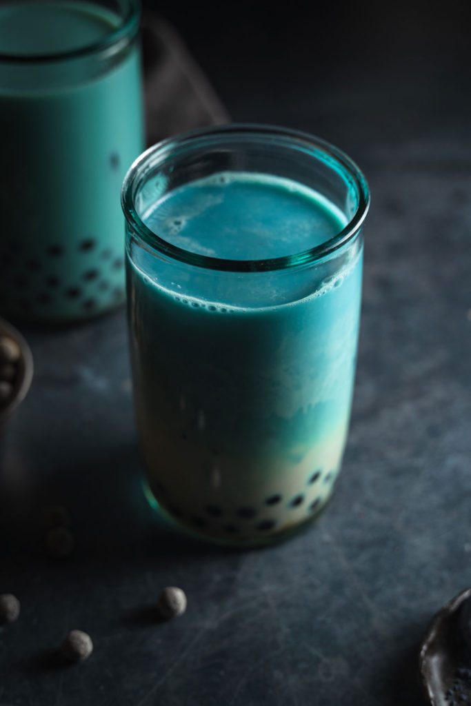 45 degree angle of the butterfly pea milk tea with boba.