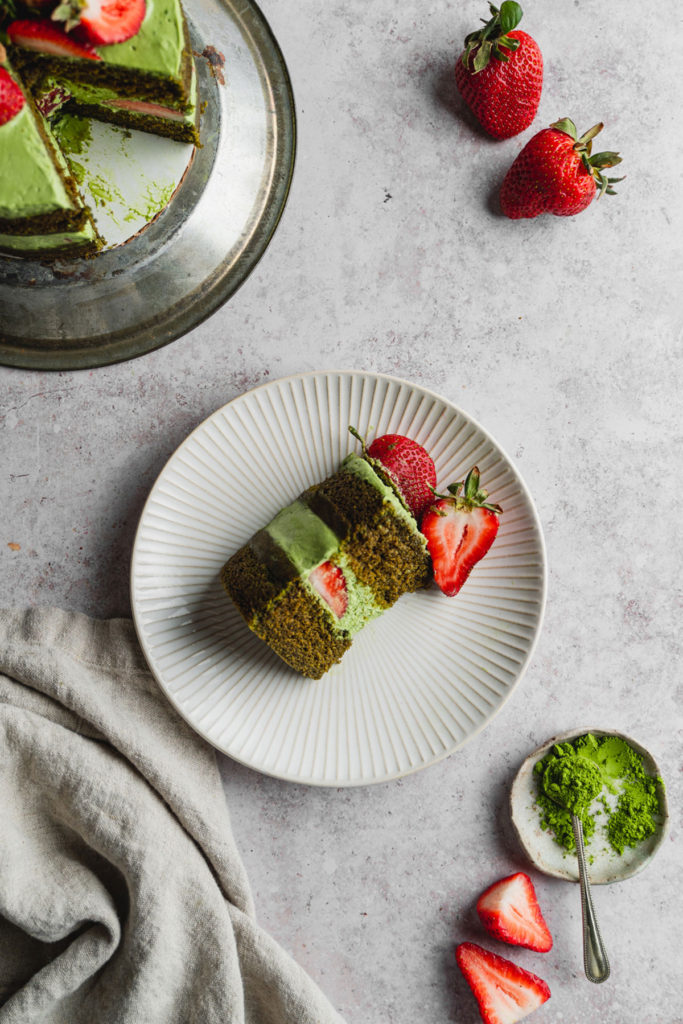 Top view of a slice of vegan matcha strawberry cake on a plate 
