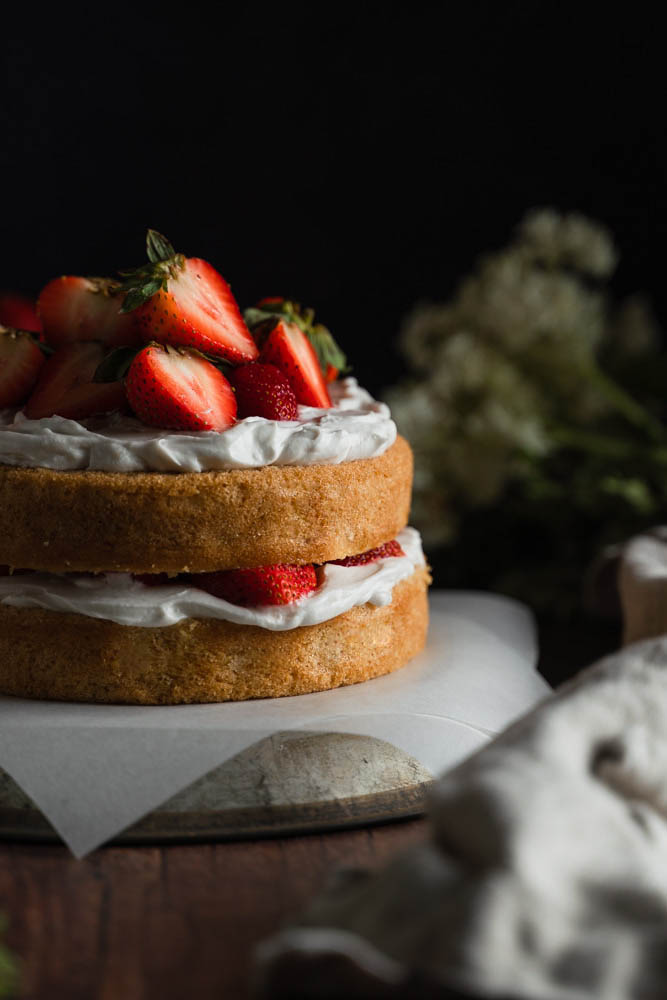 Vegan strawberry cake in front and in focus.
