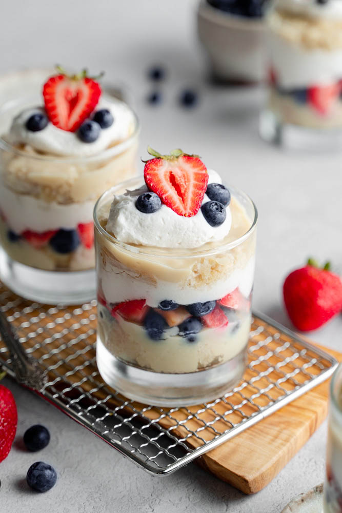 One vegan berry trifle cup in focus, and other cup in the back.