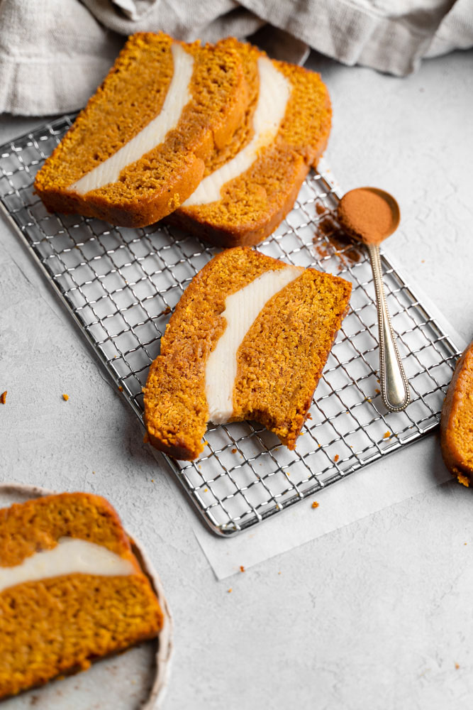 A slice of pumpkin bread with a bite taken out of it.