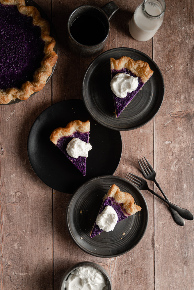 Three slices of ube pie with whipped cream on each slice