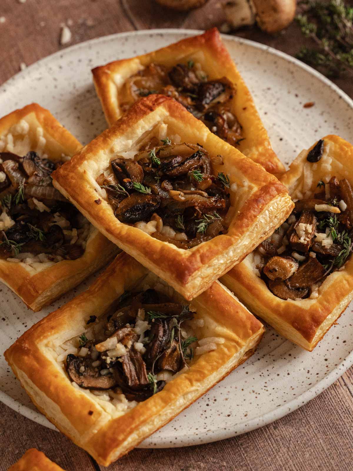 Plate of cheesy vegan mushroom tarts.