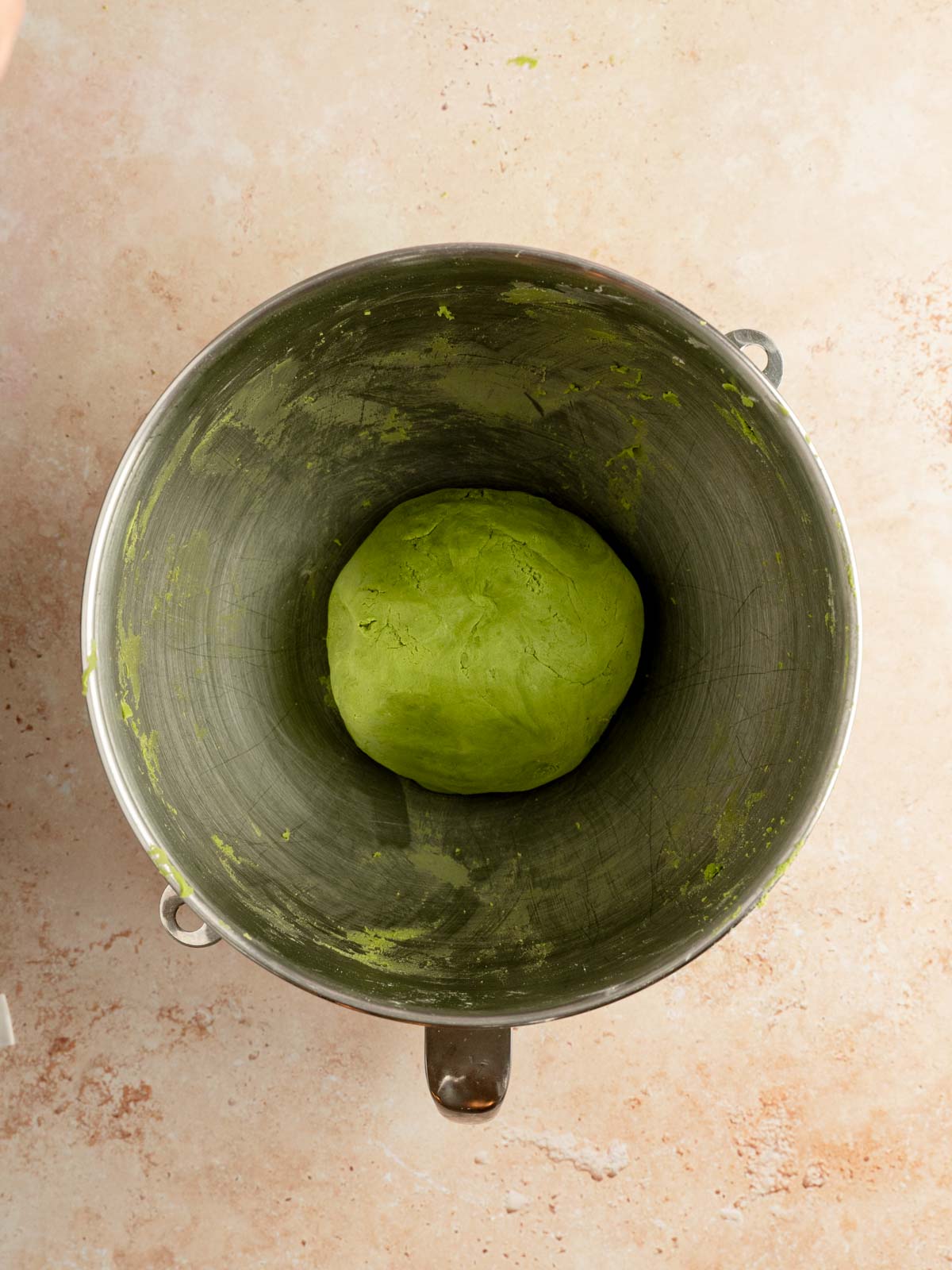 Matcha cookie dough kneaded and shaped into a ball.